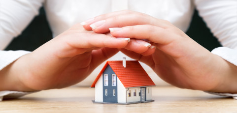 House covered of woman hands insurance real estate concept