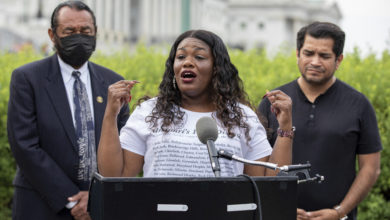 Photo of Representative Cori Bush writing book